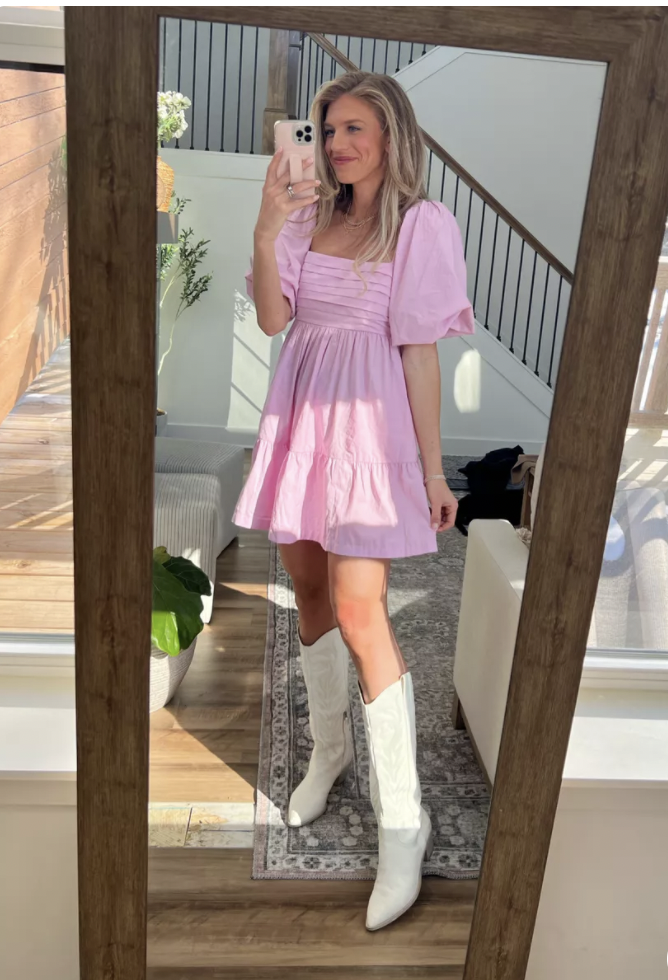 blonde in pink mini dress and white western boots